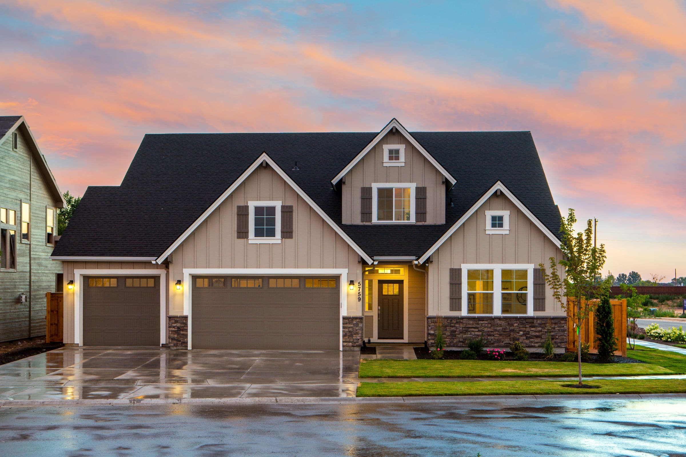 A well-kept two-story craftsman-style house at sunset, standing in for the kind of Southern California residential property PureDeal buys and improves.