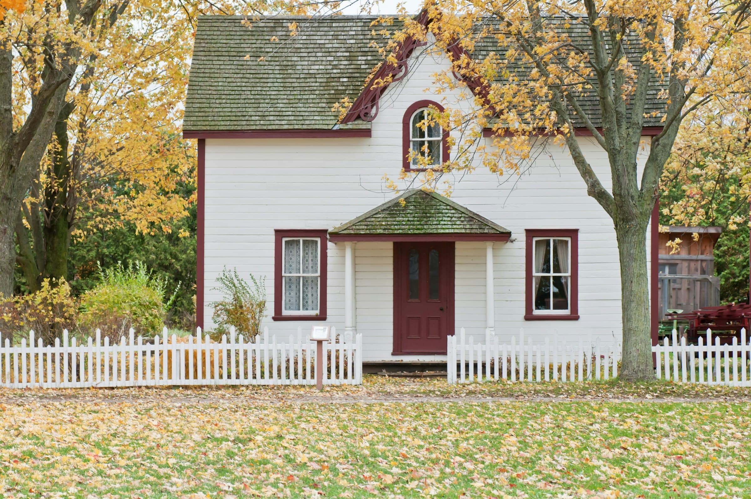 A house at dusk with interior lights on, suggesting a finished, lived-in home.